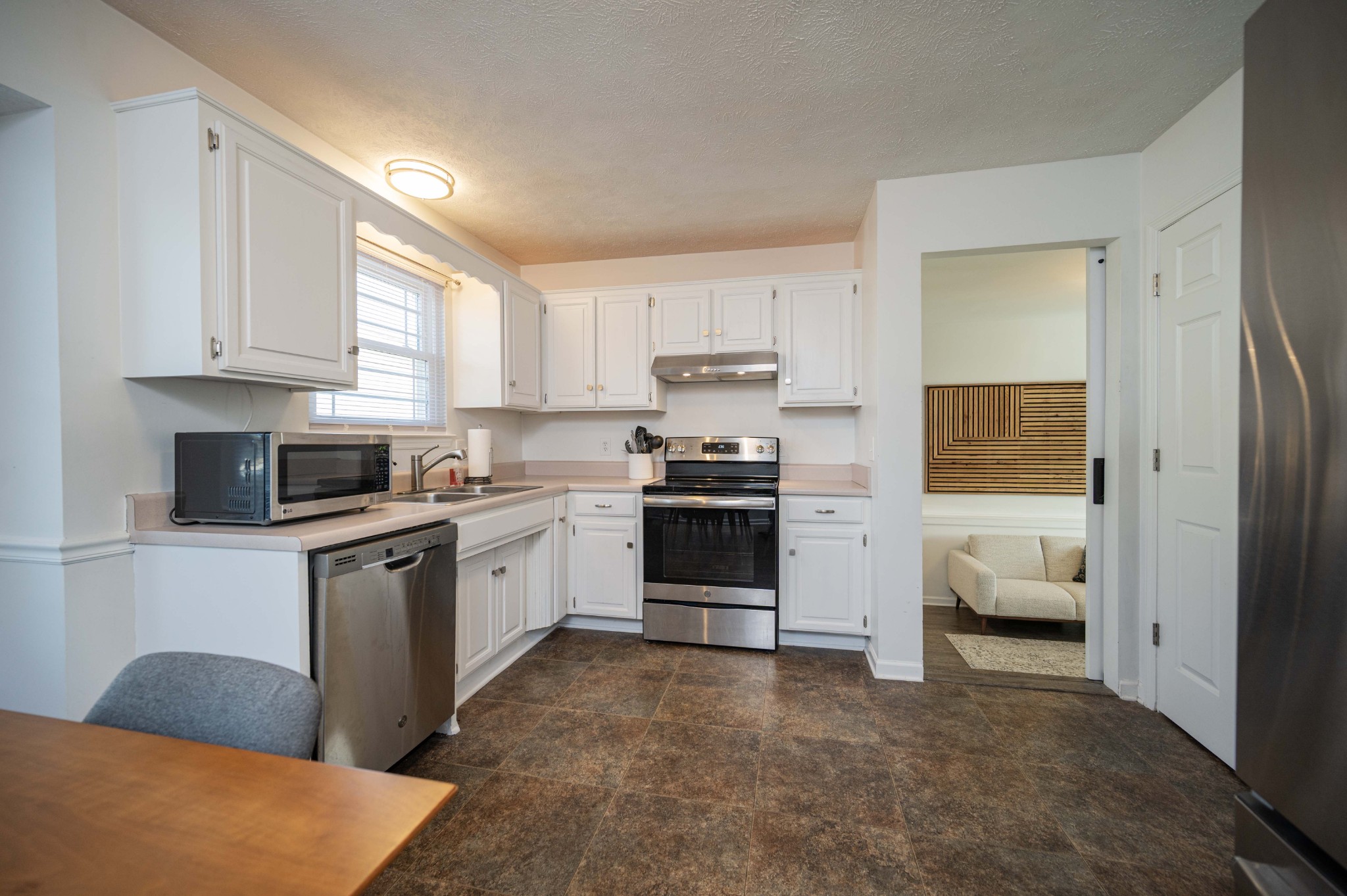 642 Rock Springs Road Smyrna, TN 37167 - Photo 18 of 49 a kitchen with granite countertop a refrigerator and white cabinets