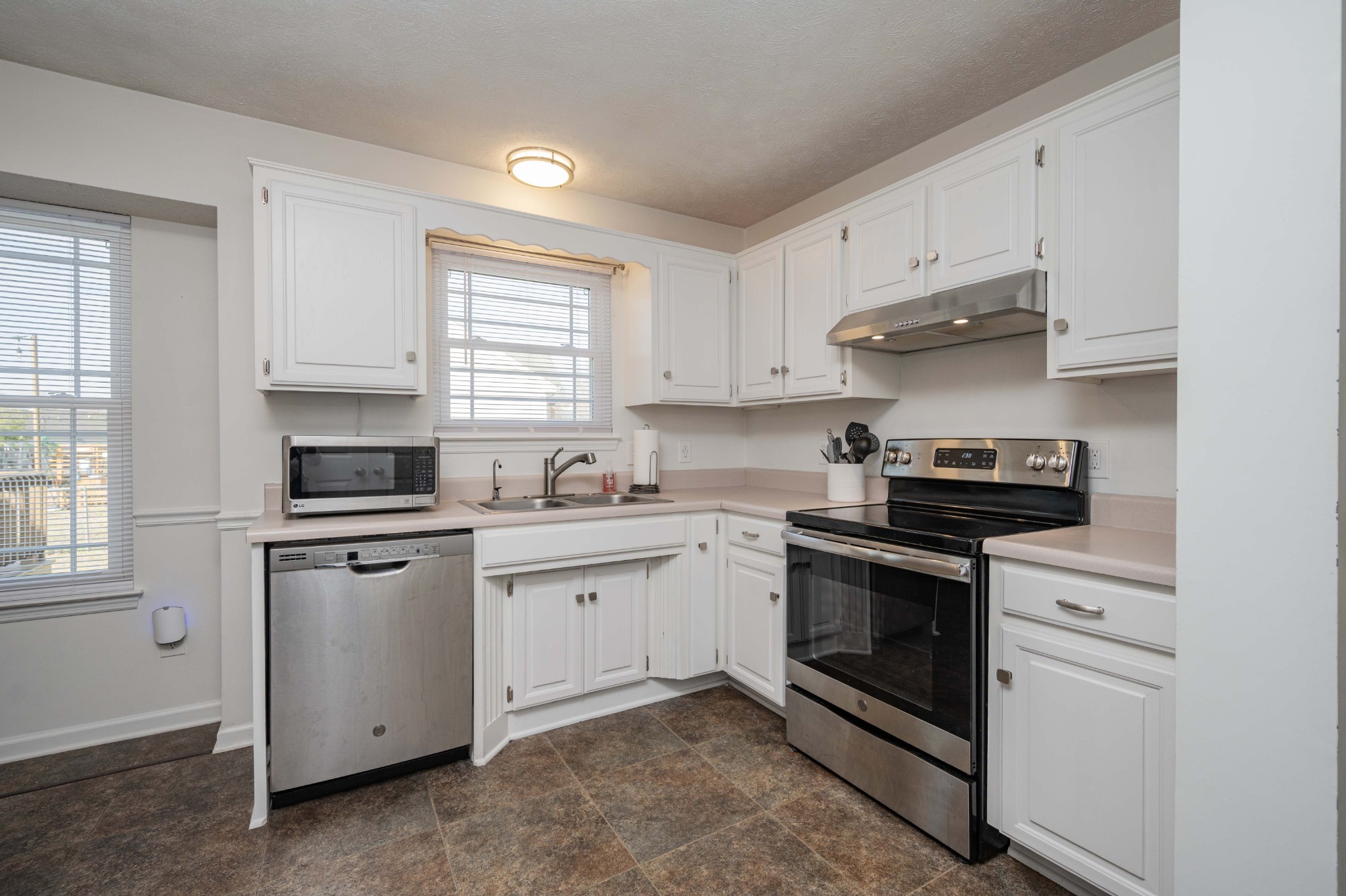 642 Rock Springs Road Smyrna, TN 37167 - Photo 20 of 49 a kitchen with granite countertop white cabinets stainless steel appliances and a window