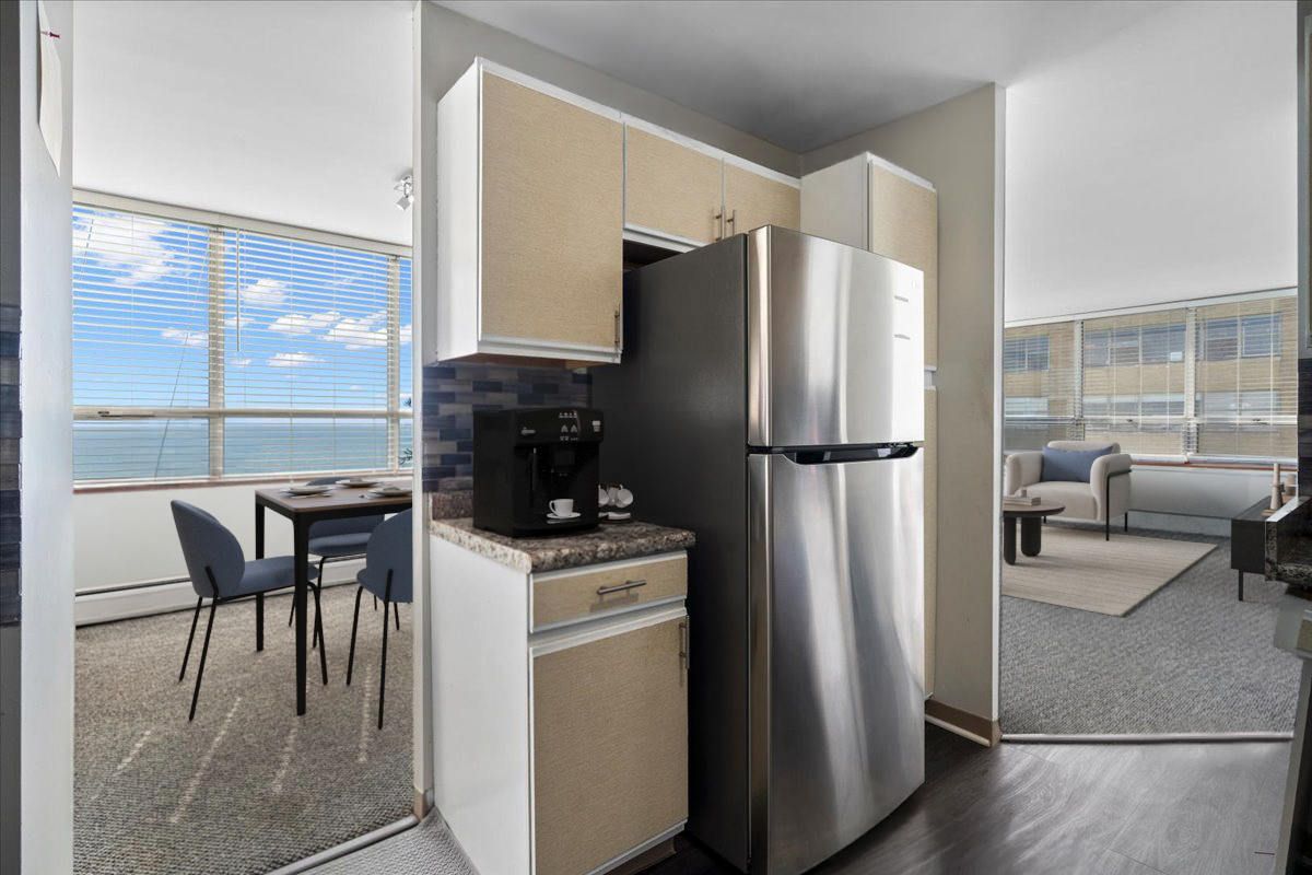 6171 North Sheridan Road, Unit 1112 Chicago, IL 60660 - Photo 8 of 23 a kitchen with a refrigerator a stove and a dining table with wooden floor