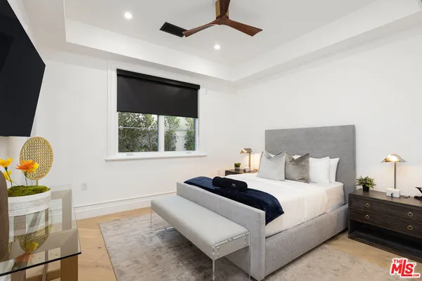 a bedroom with a bed and a painting on the wall