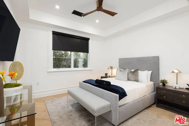 a bedroom with a bed and a painting on the wall