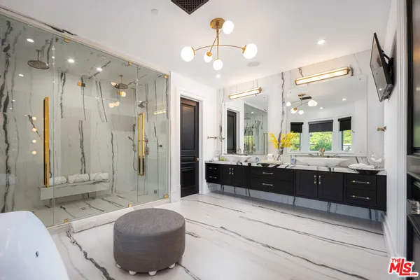 a kitchen with a sink and chairs