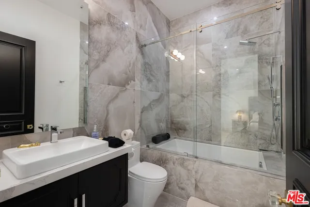 a spacious bathroom with a sink and a mirror