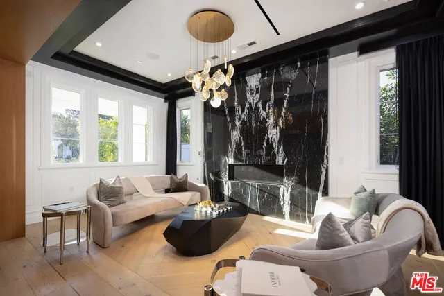 a dining hall with stainless steel appliances granite countertop a refrigerator and a sink