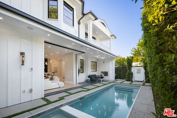 a view of a hallway with a livingroom and entryway