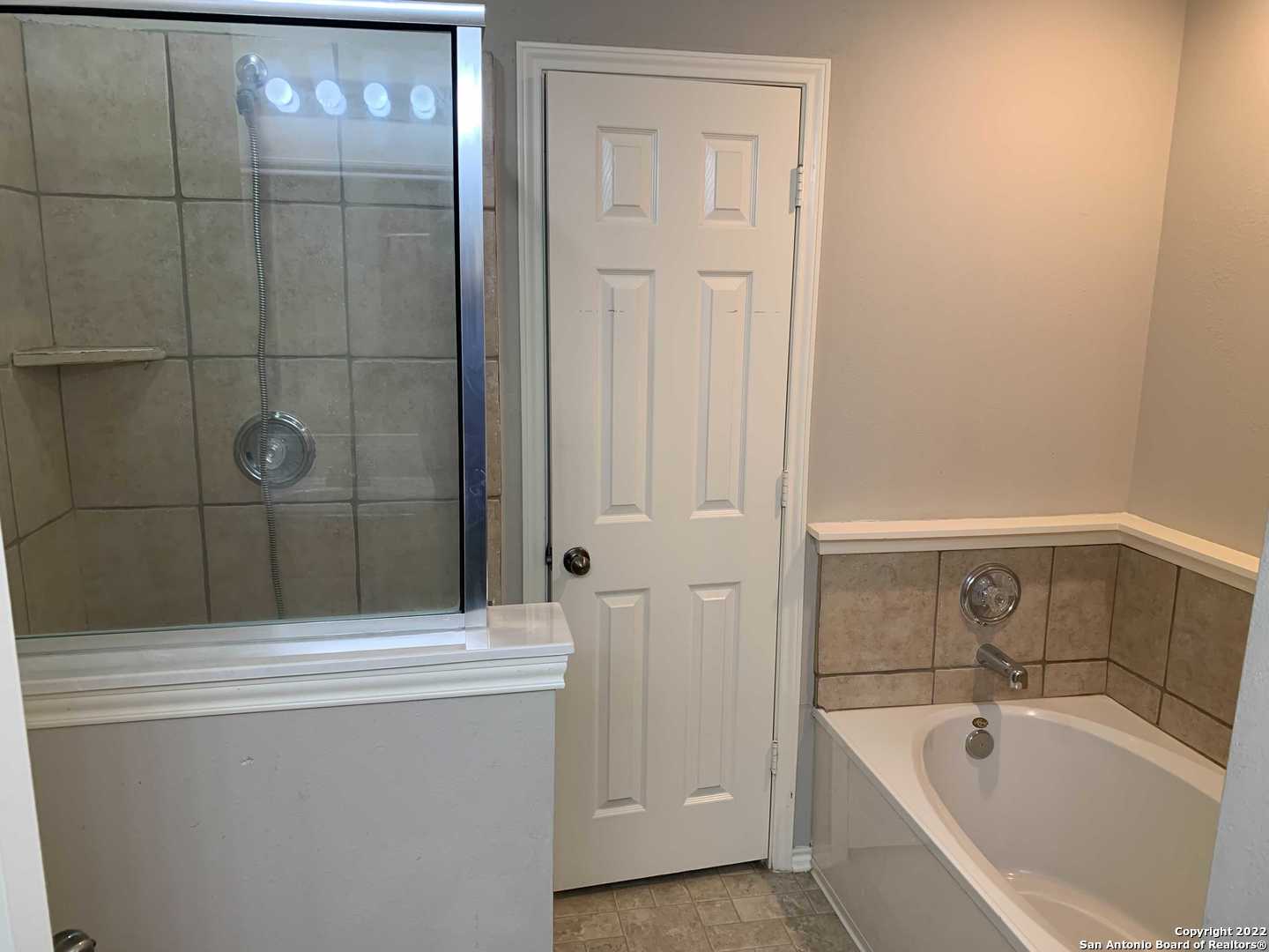 522 Cattle Ranch Drive San Antonio, TX 78245 - Photo 15 of 24 a bathroom with a tub and sink
