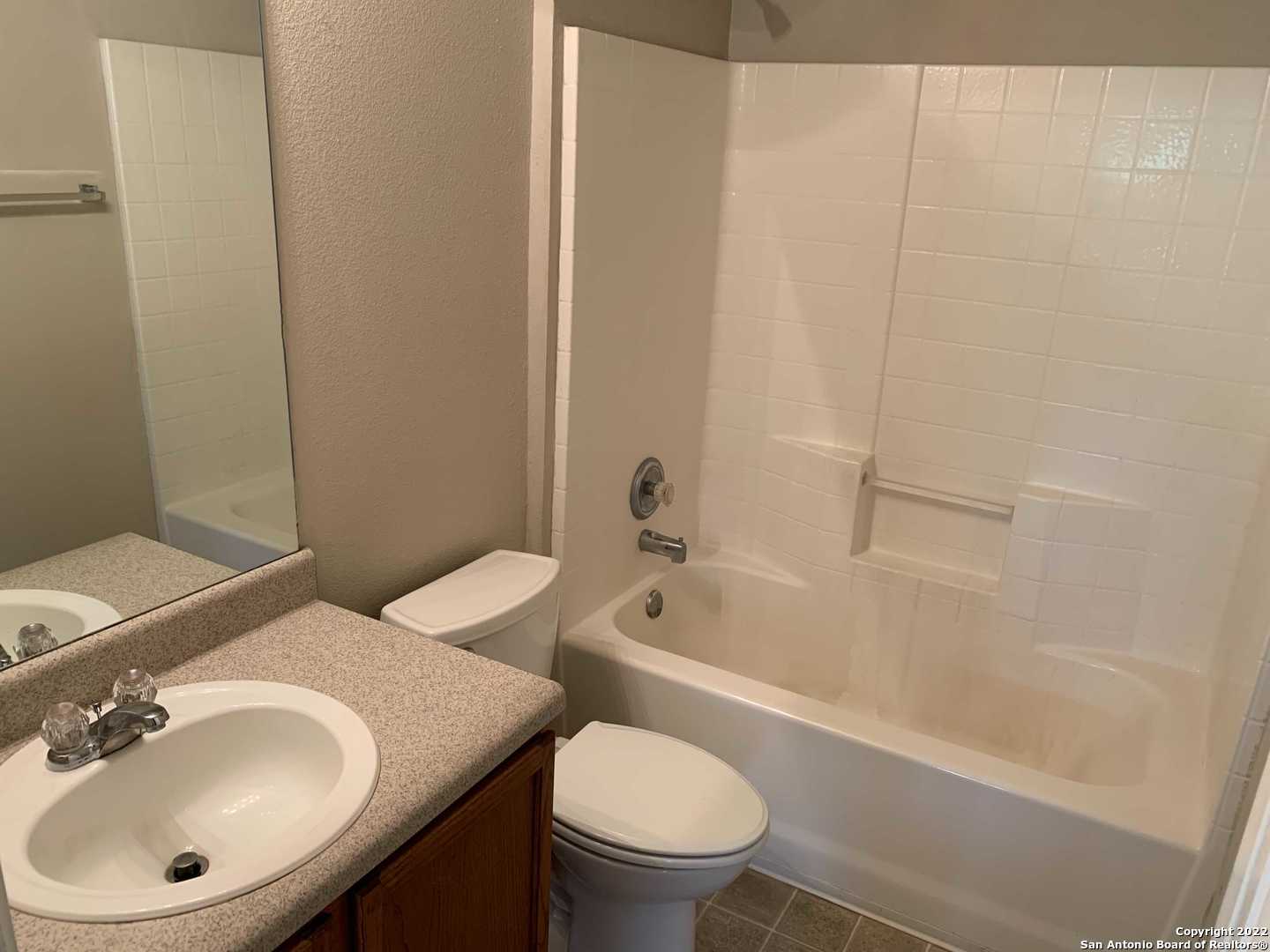 522 Cattle Ranch Drive San Antonio, TX 78245 - Photo 17 of 24 a bathroom with a sink a toilet and a bathtub