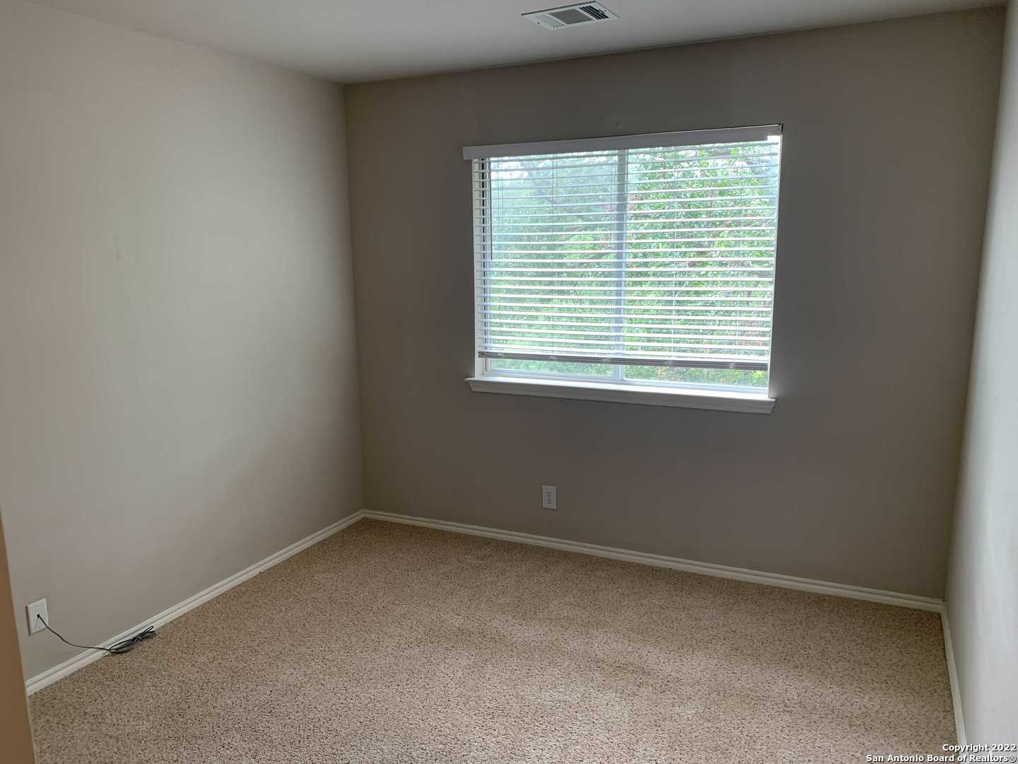 522 Cattle Ranch Drive San Antonio, TX 78245 - Photo 18 of 24 an empty room with a window