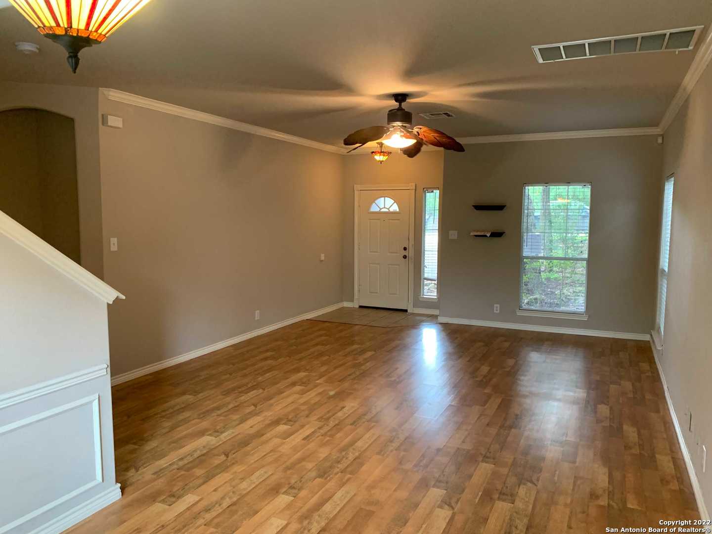 522 Cattle Ranch Drive San Antonio, TX 78245 - Photo 4 of 24 wooden floor in an empty room with a window