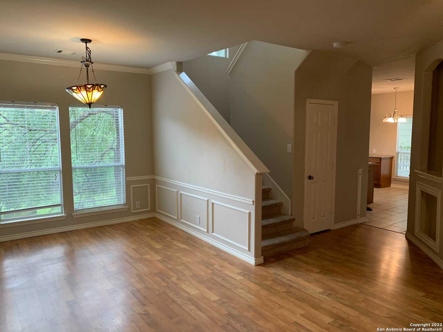 522 Cattle Ranch Drive San Antonio, TX 78245 - Photo 5 of 24 a view of livingroom with furniture wooden floor chandelier and windows