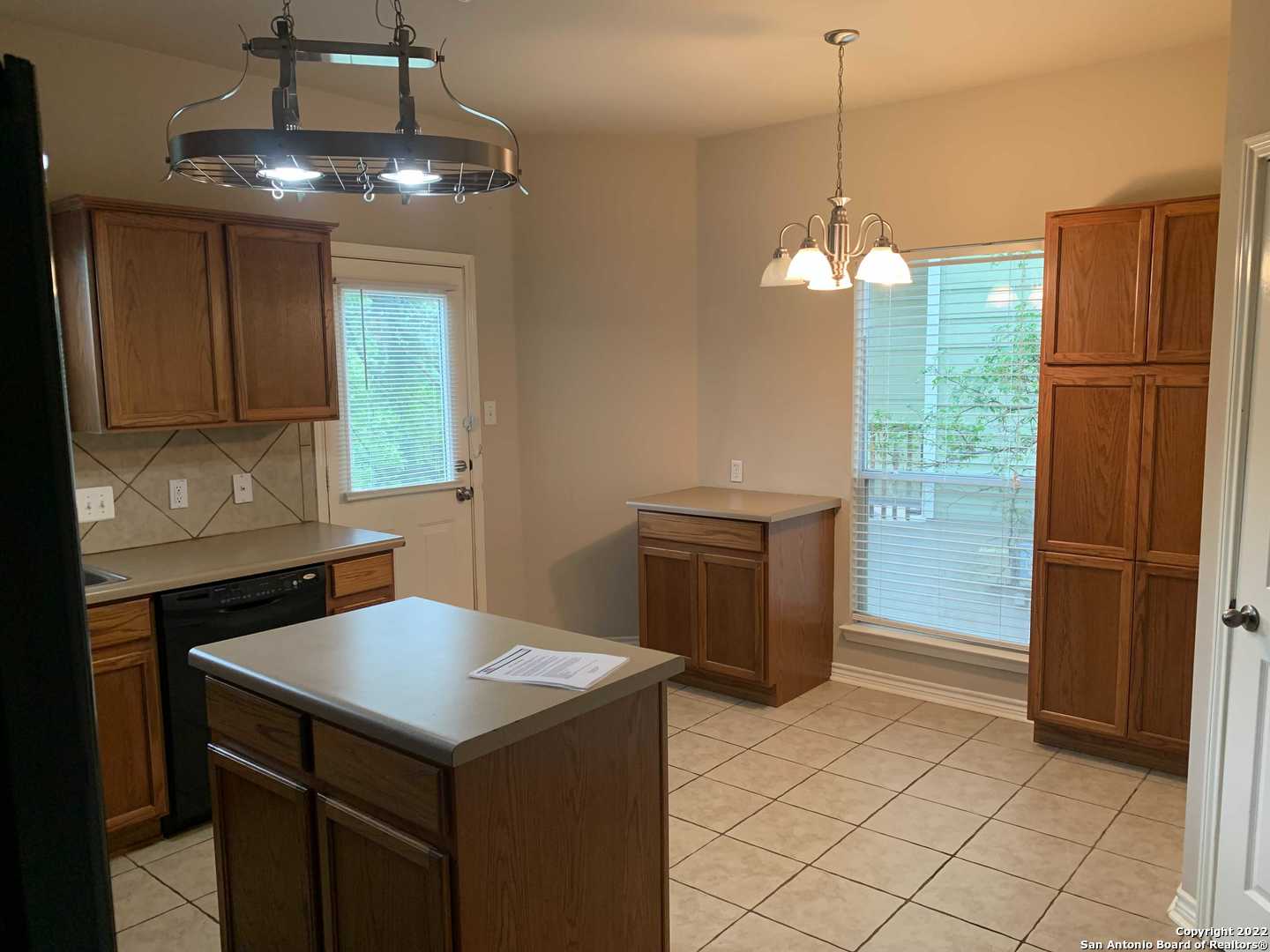 522 Cattle Ranch Drive San Antonio, TX 78245 - Photo 6 of 24 a kitchen with stainless steel appliances a stove a refrigerator and a sink