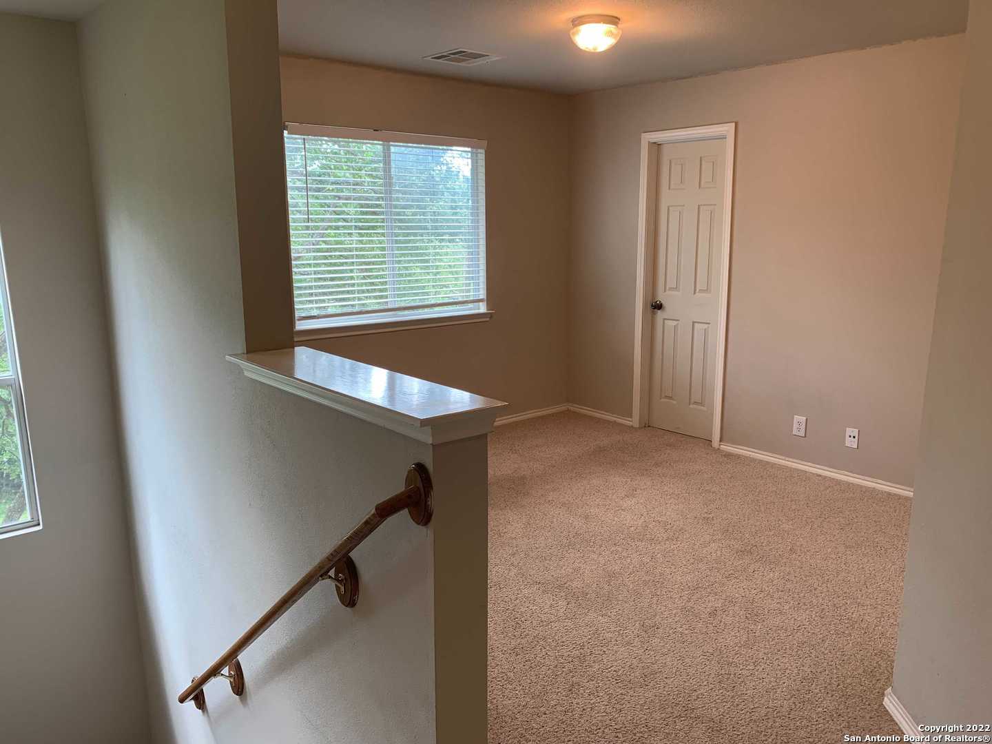 522 Cattle Ranch Drive San Antonio, TX 78245 - Photo 10 of 24 a view of an empty room with a window