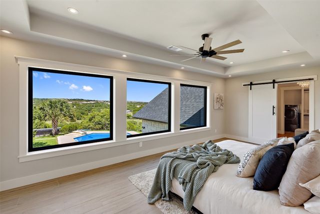 a bed sitting in a room next to a large window