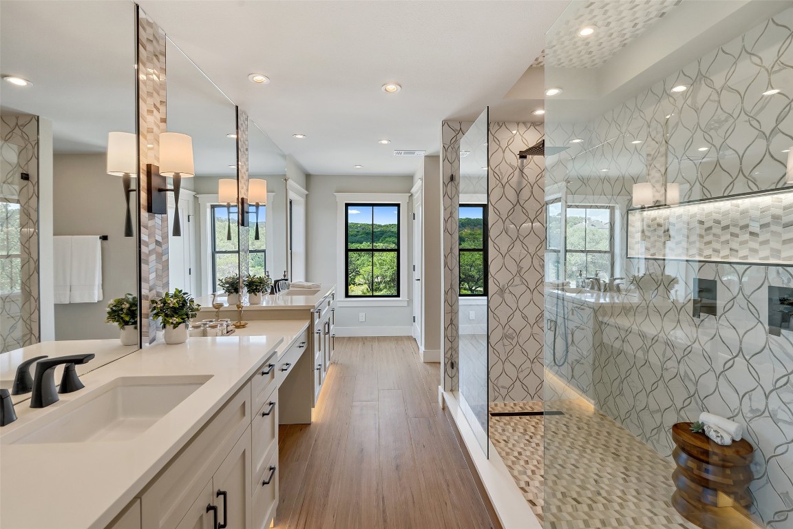 13824 Lone Rider Trail Austin, TX 78738 - Photo 13 of 40 a bathroom with a sink a large mirror and shower