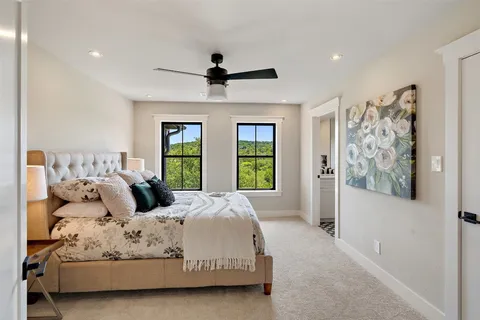 a bedroom with a large bed and a window