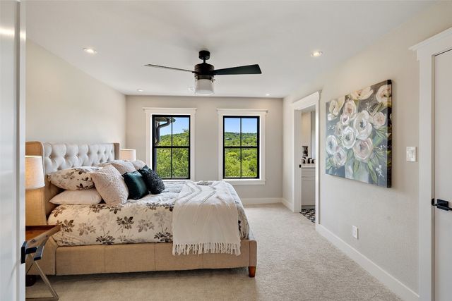 a bedroom with a large bed and a window