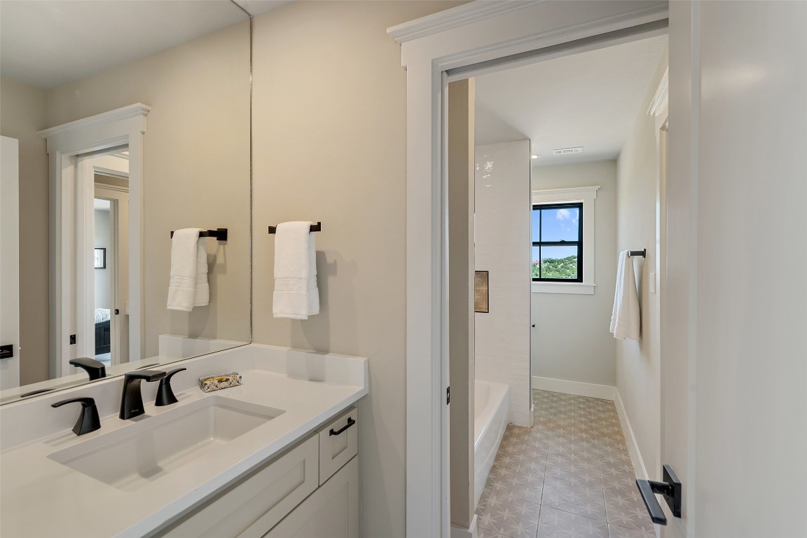 13824 Lone Rider Trail Austin, TX 78738 - Photo 17 of 40 a bathroom with a sink and a mirror