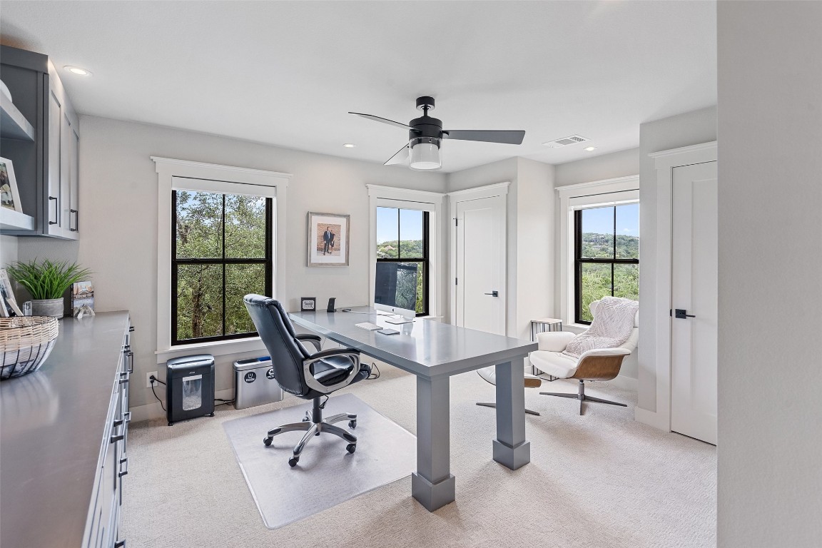 13824 Lone Rider Trail Austin, TX 78738 - Photo 19 of 40 a view of a workspace with furniture and a window