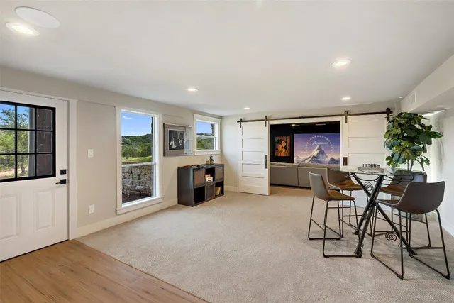 a living room with furniture a fireplace and a potted plant