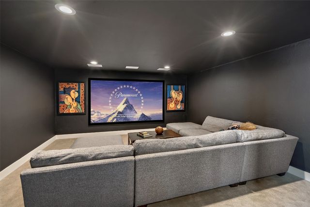 a living room with furniture and screen