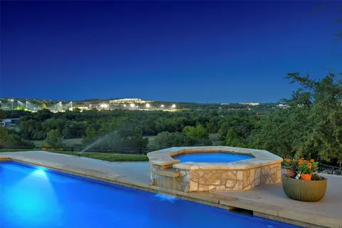 a view of a swimming pool with a yard