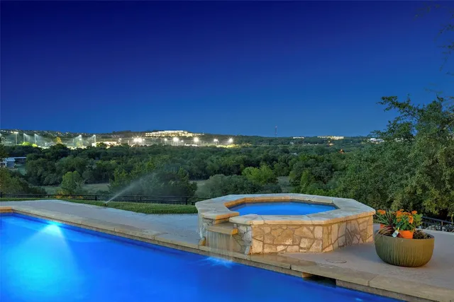 a view of a swimming pool with a yard