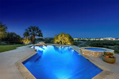 a view of a swimming pool with a yard