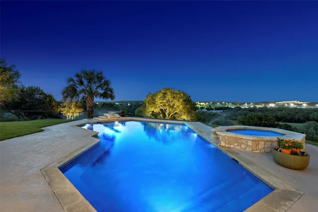 a view of a swimming pool with a yard