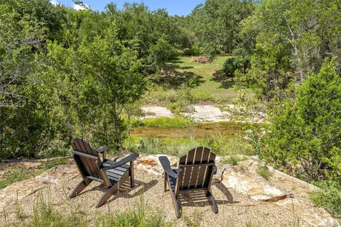 a roof deck with table and chairs and wooden floor