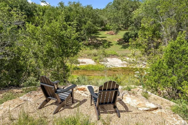a roof deck with table and chairs and wooden floor