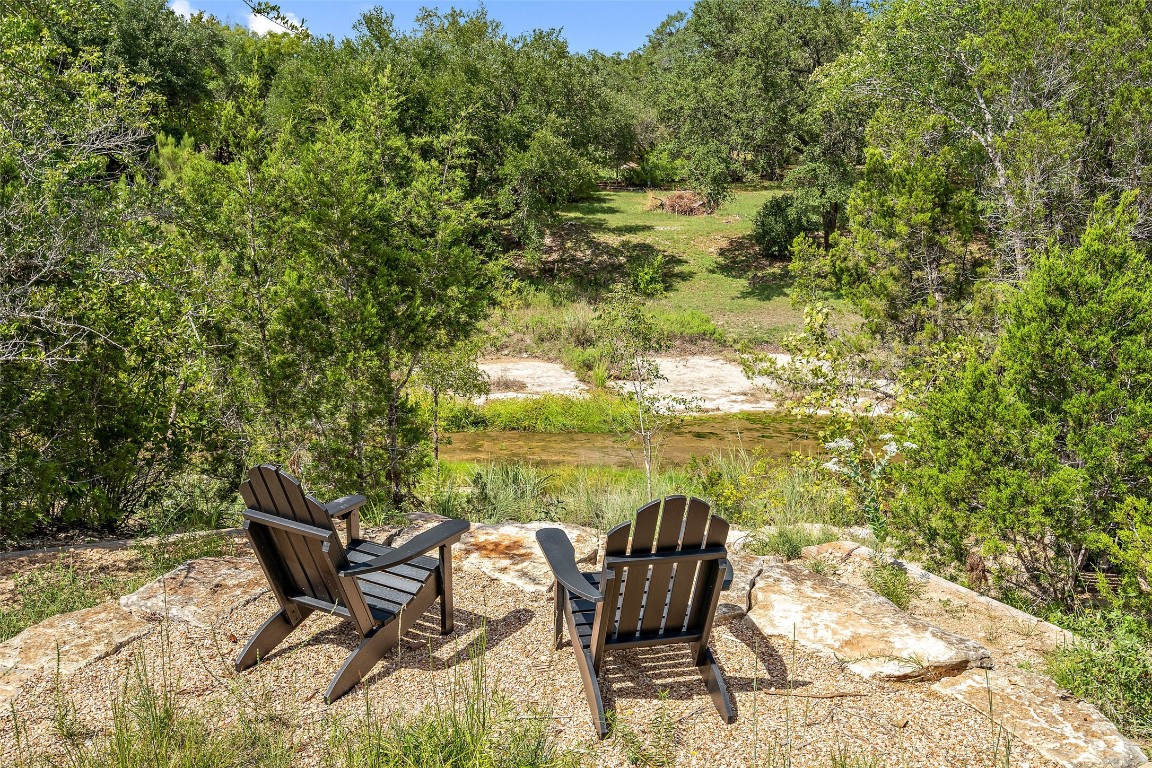 13824 Lone Rider Trail Austin, TX 78738 - Photo 30 of 40 a roof deck with table and chairs and wooden floor