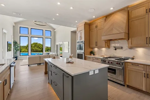 a kitchen with a sink stove and cabinets