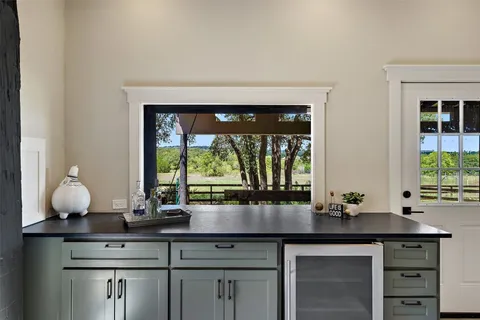 a kitchen with a sink and large window