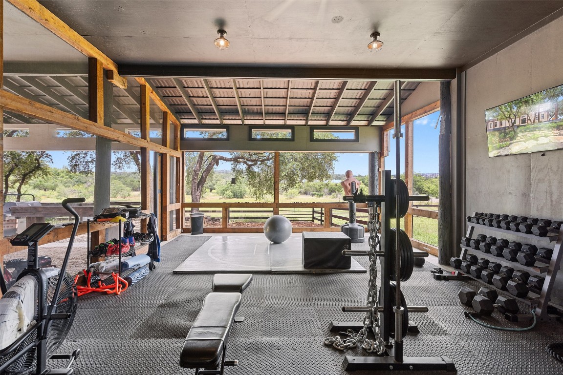 13824 Lone Rider Trail Austin, TX 78738 - Photo 36 of 40 a room with gym equipment and floor to ceiling window