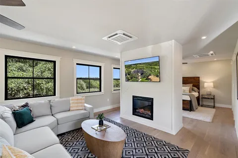 a living room with furniture a rug and a fireplace