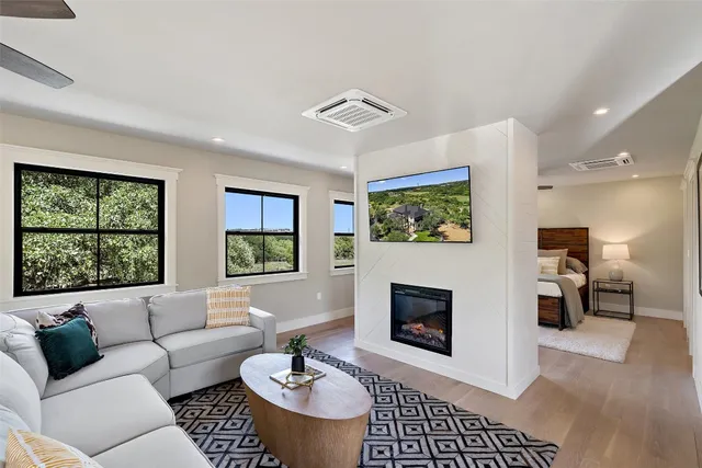 a living room with furniture a rug and a fireplace