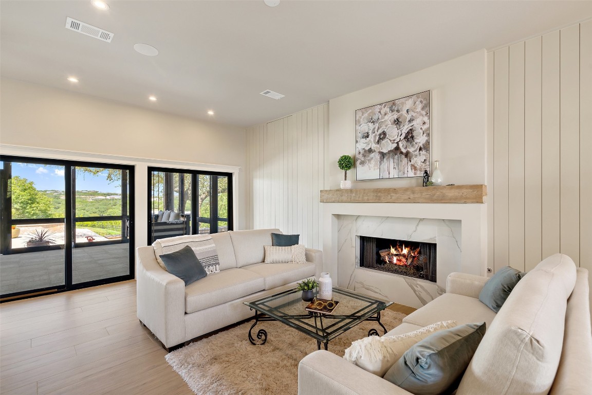 13824 Lone Rider Trail Austin, TX 78738 - Photo 8 of 40 a living room with furniture and a fireplace