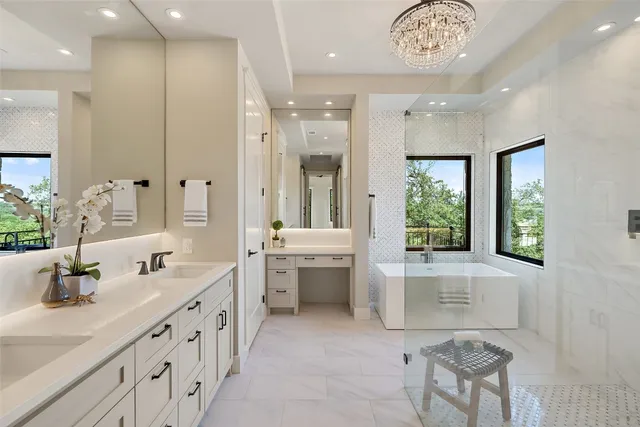 a bathroom with a double vanity sink a toilet a mirror and shower