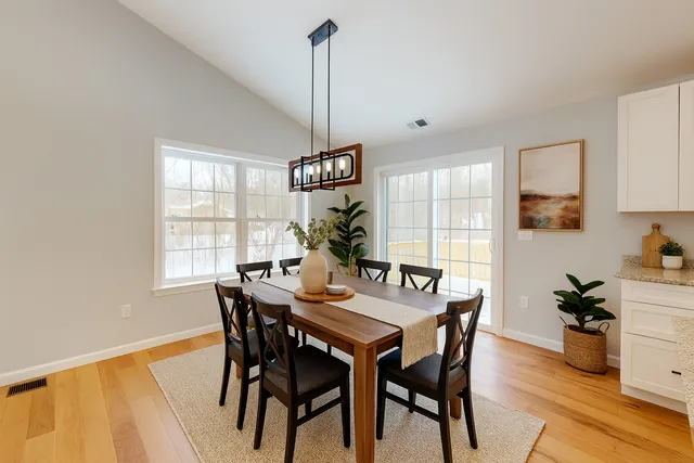 a view of a dining room with furniture window and wooden floor