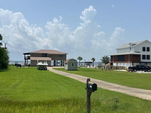 1076 Pearson Road Milton, FL 32583 - Photo 4 of 6 a front view of a house with a garden