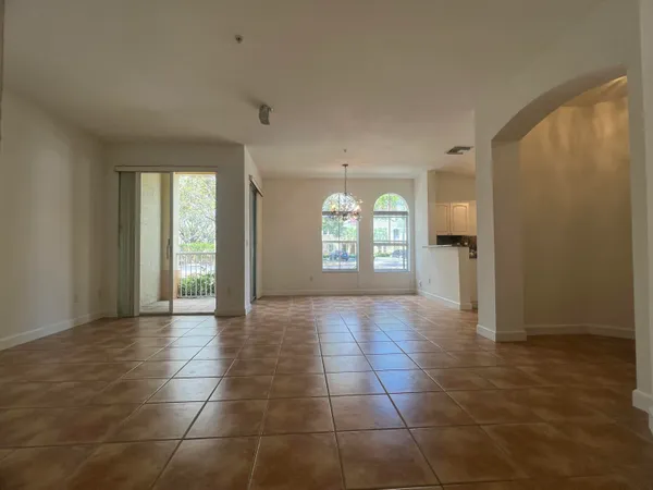 an empty room with windows and entrance