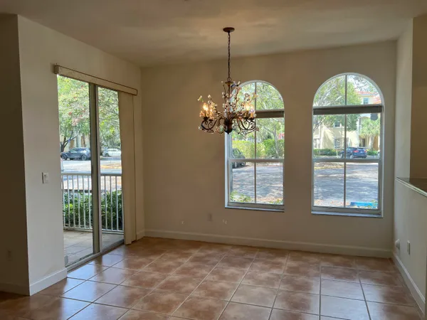 a view of a room with windows and chandelier