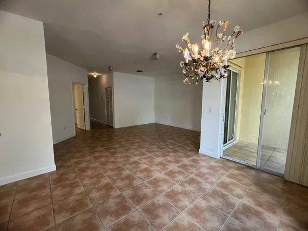 an empty room with a chandelier and living room