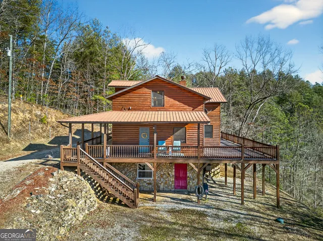 a view of a house with a yard and sitting area