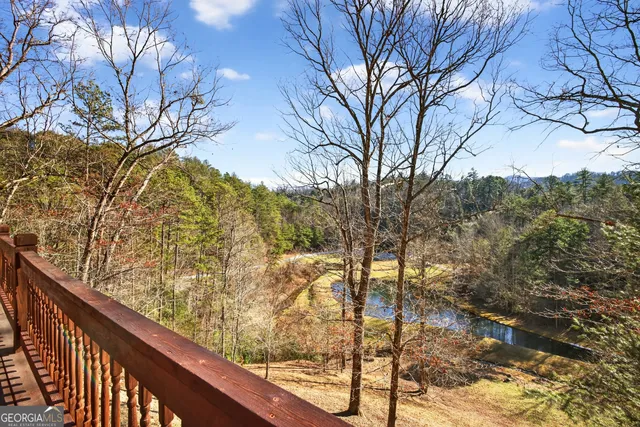 a view of balcony with wooden floor and fence
