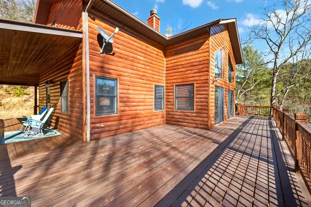 a view of balcony with wooden floor and fence
