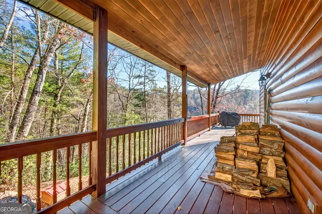 a view of a dining room with furniture a chandelier and wooden floor