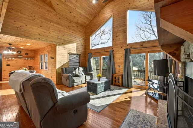 a kitchen with stainless steel appliances kitchen island granite countertop wooden cabinets and a stove
