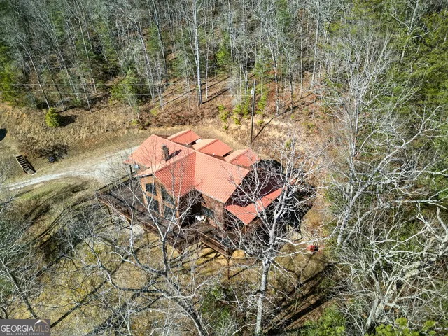a backyard of a house with yard and outdoor seating