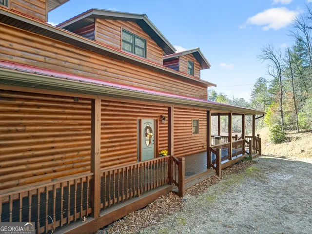 a front view of a house with a yard and balcony